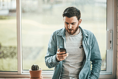 man checking his phone for texts